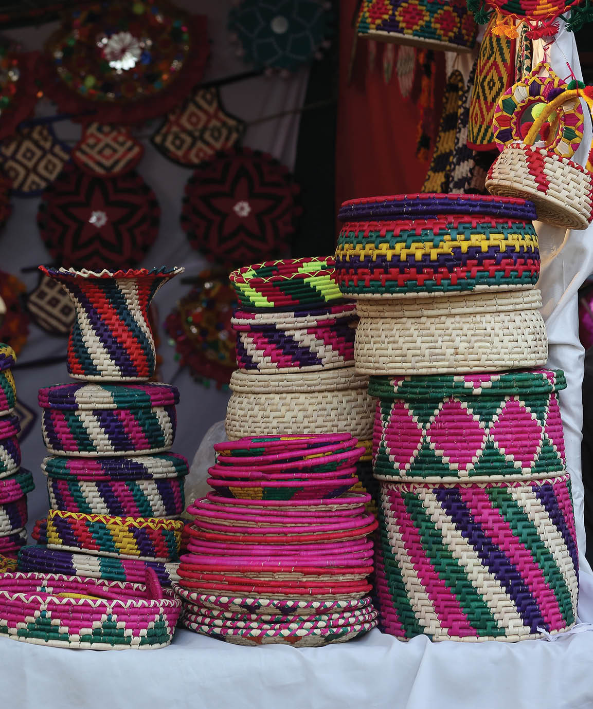 Stack of traditional Plates and handmade ceramics, handmade colorful dishes , Handicraft kettle item, Colorful Handmade Pottery and Ceramics, Souvenir Shop in lok virsa mela Islam